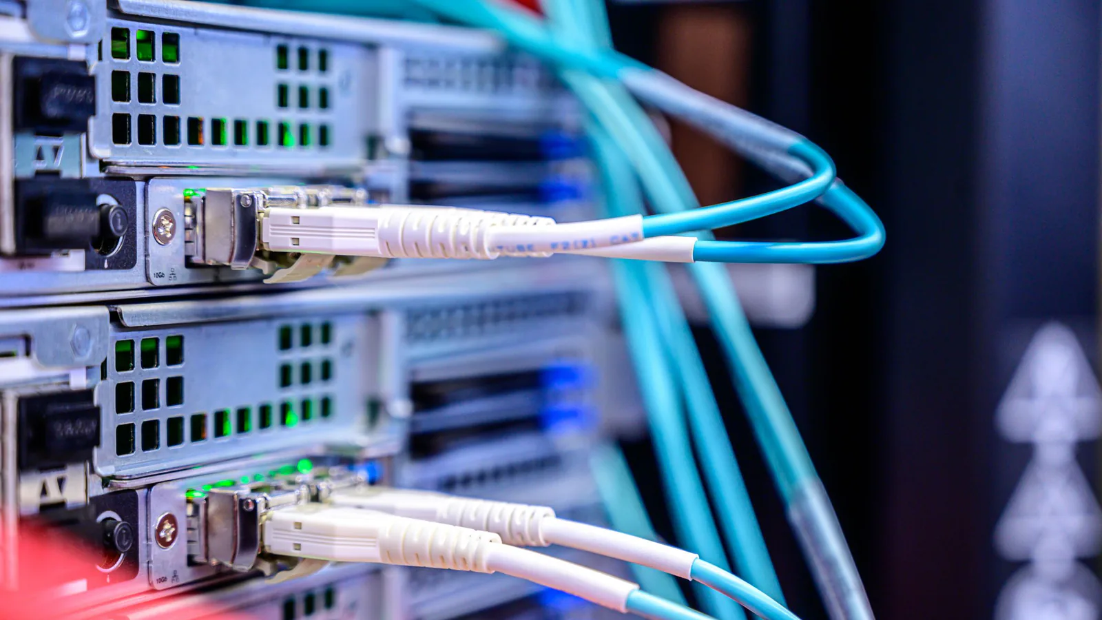 Fiber patch cables plugged into rack servers with green port lights, the hardware AI crawlers request pages from